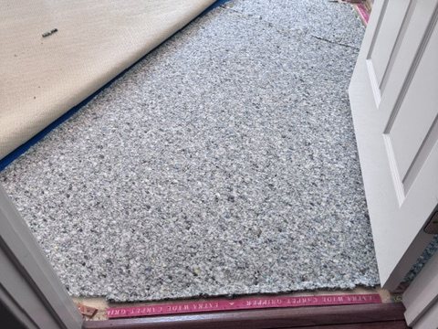 Carpet service in progress with the carpet edge lifted